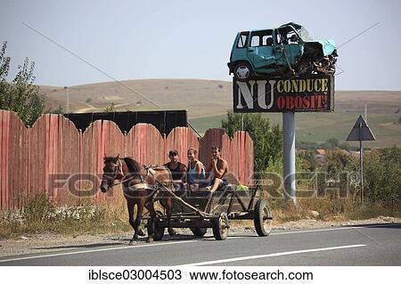 "Horse-drawn carriage in traffic, a car wreck is mounted on a pole with a warning sign, Rupea, Siebenburgen, Romania, Europe" View Large Photo Image Stock Image - "Horse-drawn carriage in traffic, a car wreck is mounted on a pole with a warning sign, Rupea, Siebenburgen, Romania, Europe". Fotosearch