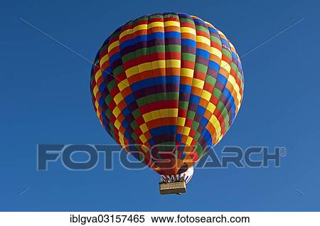 Stock Photography - "Hot air balloon floating in front of a blue sky, Goreme, Cappadocia, Nevsehir Province, Central Anatolia Region, Turkey, Asia". Fotosearch