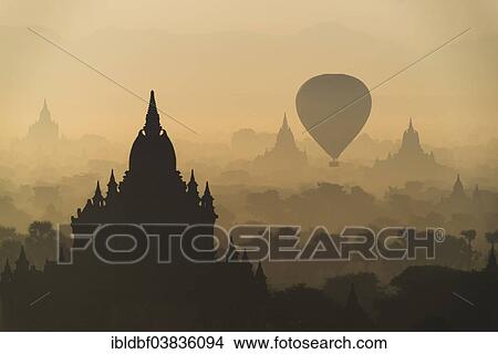 "Hot air balloon over the landscape in the early morning fog, temples, stupas, pagodas, temple complex, Plateau of Bagan, Mandalay Division, Burma or Myanmar" View Large Photo Image Picture - "Hot air balloon over the landscape in the early morning fog, temples, stupas, pagodas, temple complex, Plateau of Bagan, Mandalay Division, Burma or Myanmar". Fotosearch