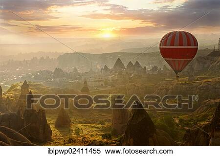 "Hot air balloon over volcanic tuff rock formations at dawn, Goreme, Cappadocia, Turkey, Asia" View Large Photo Image Stock Photography - "Hot air balloon over volcanic tuff rock formations at dawn, Goreme, Cappadocia, Turkey, Asia". Fotosearch