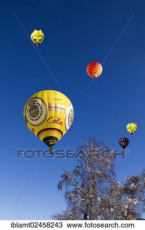 Stock Image - "Hot air balloons against a blue sky, 12th balloon festival of Tegernsee, Montgolfiade, Bad Wiessee, Tegernsee, Bavaria, Germany, Europe., Europe". Fotosearch