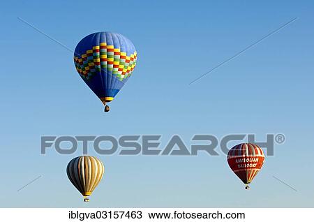 "Hot air balloons floating against a blue sky, Goreme, Cappadocia, Nevsehir Province, Central Anatolia Region, Turkey, Asia" View Large Photo Image Stock Image - "Hot air balloons floating against a blue sky, Goreme, Cappadocia, Nevsehir Province, Central Anatolia Region, Turkey, Asia". Fotosearch