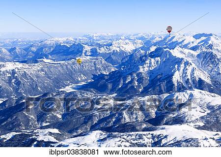Stock Image - "Hot air balloons flying over the Alps, Unterinntal, Tyrol, Austria, Europe". Fotosearch