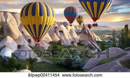 "Hot air balloons over Goreme volcanic tuff rock formations at dawn, Cappadocia, Turkey, Asia" View Large Photo Image Picture - "Hot air balloons over Goreme volcanic tuff rock formations at dawn, Cappadocia, Turkey, Asia". Fotosearch