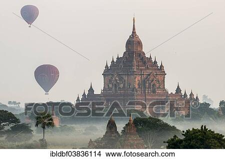 "Hot air balloons over the landscape in the early morning fog, temples, stupas, pagodas, temple complex, Plateau of Bagan, Mandalay Division, Burma or Myanmar" View Large Photo Image Picture - "Hot air balloons over the landscape in the early morning fog, temples, stupas, pagodas, temple complex, Plateau of Bagan, Mandalay Division, Burma or Myanmar". Fotosearch