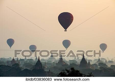 "Hot air balloons over the landscape in the early morning fog, temples, stupas, pagodas, temple complex, Plateau of Bagan, Mandalay Division, Burma or Myanmar" View Large Photo Image Stock Image - "Hot air balloons over the landscape in the early morning fog, temples, stupas, pagodas, temple complex, Plateau of Bagan, Mandalay Division, Burma or Myanmar". Fotosearch
