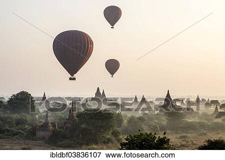 "Hot air balloons over the landscape in the early morning fog, temples, stupas, pagodas, temple complex, Plateau of Bagan, Mandalay Division, Burma or Myanmar" View Large Photo Image Stock Photo - "Hot air balloons over the landscape in the early morning fog, temples, stupas, pagodas, temple complex, Plateau of Bagan, Mandalay Division, Burma or Myanmar". Fotosearch