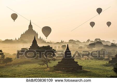 Stock Photo - "Hot air balloons over the landscape in the early morning fog, Sulamani Temple, stupas, pagodas, temple complex, Plateau of Bagan, Mandalay Division, Burma or Myanmar". Fotosearch