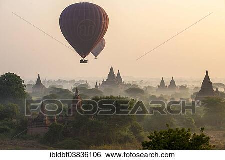 "Hot air balloons over the landscape in the early morning fog, temples, stupas, pagodas, temple complex, Plateau of Bagan, Mandalay Division, Burma or Myanmar" View Large Photo Image Stock Photograph - "Hot air balloons over the landscape in the early morning fog, temples, stupas, pagodas, temple complex, Plateau of Bagan, Mandalay Division, Burma or Myanmar". Fotosearch