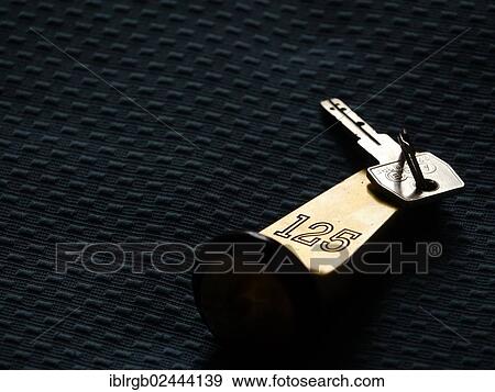 Stock Photo - Hotel key lying on a hotel bed. Fotosearch