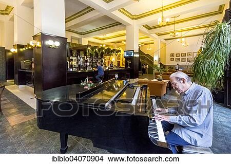 Picture - "Hotel lobby with a piano player, Amos Mundos Hotel, the hotel of writer Ernest Hemingway, Havana, Cuba, North America". Fotosearch
