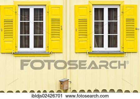 "House facade with yellow shutters and a birdhouse, Freiburg im Breisgau, Black Forest, Baden-Wuerttemberg, Germany, Europe" View Large Photo Image Stock Image - "House facade with yellow shutters and a birdhouse, Freiburg im Breisgau, Black Forest, Baden-Wuerttemberg, Germany, Europe". Fotosearch