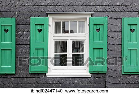 Stock Image - "House front with slate and with a heart in the shutters, Lennep, Remscheid, Bergisches Land region, North Rhine-Westphalia, Germany, Europe". Fotosearch