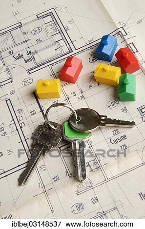 "House keys and miniature houses on a construction plan, symbolic image for real estate market, France, Europe" View Large Photo Image Stock Photo - "House keys and miniature houses on a construction plan, symbolic image for real estate market, France, Europe". Fotosearch