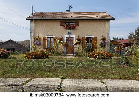"House with many flowers, lock No. 45, on the Canal des Vosges, formerly Canal de l'Est, Corre, Vesoul, Region Franche-Comte, Dep. Haute-Saone, France, Europe" View Large Photo Image Picture - "House with many flowers, lock No. 45, on the Canal des Vosges, formerly Canal de l'Est, Corre, Vesoul, Region Franche-Comte, Dep. Haute-Saone, France, Europe". Fotosearch