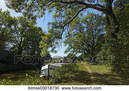 "Houseboat during a lunch break on the Canal des Vosges, formerly the Canal de l'Est, at PK 95, summit level of the canal, Chaumousey, Epinal, Lorraine, Departement Vosges, France, Europe" View Large Photo Image Stock Image - "Houseboat during a lunch break on the Canal des Vosges, formerly the Canal de l'Est, at PK 95, summit level of the canal, Chaumousey, Epinal, Lorraine, Departement Vosges, France, Europe". Fotosearch