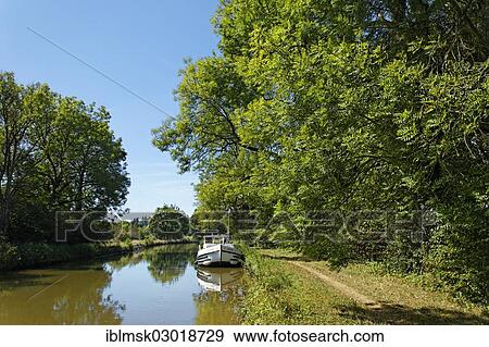 "Houseboat during a lunch break on the Canal des Vosges, formerly the Canal de l'Est, at PK 95, summit level of the canal, Chaumousey, Epinal, Lorraine, Departement Vosges, France, Europe" View Large Photo Image Stock Photo - "Houseboat during a lunch break on the Canal des Vosges, formerly the Canal de l'Est, at PK 95, summit level of the canal, Chaumousey, Epinal, Lorraine, Departement Vosges, France, Europe". Fotosearch
