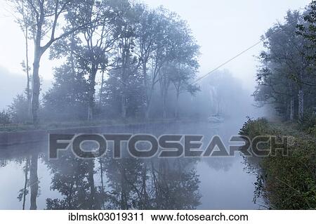 "Houseboat on the Canal des Vosges, formerly Canal de l'Est, overnight stay at PK 100. 5, with morning fog, Girancourt, Epinal, Lorraine, Departement Vosges, France, Europe" View Large Photo Image Stock Image - "Houseboat on the Canal des Vosges, formerly Canal de l'Est, overnight stay at PK 100. 5, with morning fog, Girancourt, Epinal, Lorraine, Departement Vosges, France, Europe". Fotosearch