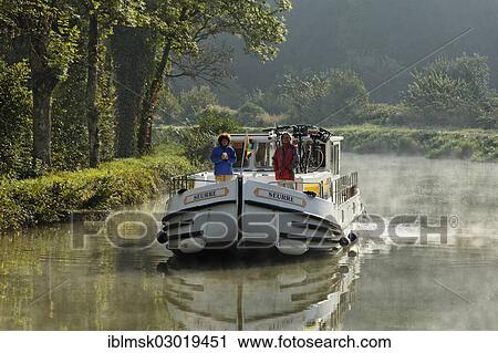 "Houseboat on the Canal des Vosges, formerly Canal de l'Est, southwest of the village at about 127 PK, in the morning, Fontenoy-le-Chateau, Epinal, Lorraine, Departement Vosges, France, Europe" View Large Photo Image Stock Image - "Houseboat on the Canal des Vosges, formerly Canal de l'Est, southwest of the village at about 127 PK, in the morning, Fontenoy-le-Chateau, Epinal, Lorraine, Departement Vosges, France, Europe". Fotosearch