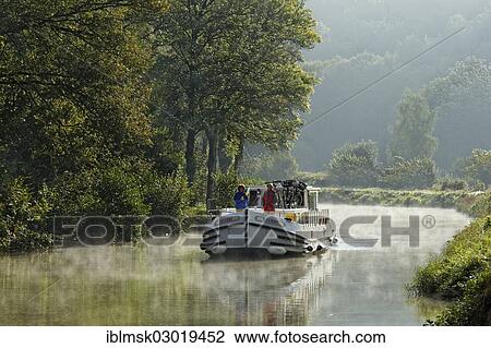 "Houseboat on the Canal des Vosges, formerly Canal de l'Est, southwest of the village at about 127 PK, in the morning, Fontenoy-le-Chateau, Epinal, Lorraine, Departement Vosges, France, Europe" View Large Photo Image Stock Image - "Houseboat on the Canal des Vosges, formerly Canal de l'Est, southwest of the village at about 127 PK, in the morning, Fontenoy-le-Chateau, Epinal, Lorraine, Departement Vosges, France, Europe". Fotosearch