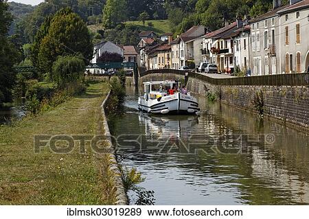 "Houseboat on the Canal des Vosges, formerly Canal de l'Est, passing through a village, Fontenoy-le-Chateau, Epinal, Lorraine, Departement Vosges, France, Europe" View Large Photo Image Stock Photo - "Houseboat on the Canal des Vosges, formerly Canal de l'Est, passing through a village, Fontenoy-le-Chateau, Epinal, Lorraine, Departement Vosges, France, Europe". Fotosearch