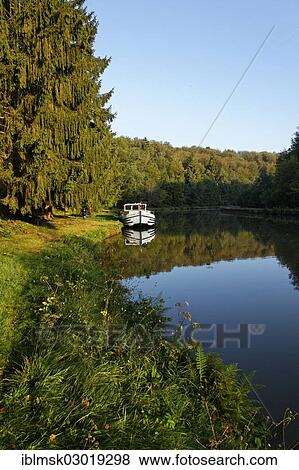 "Houseboat on the Canal des Vosges, formerly Canal de l'Est, landing in the forest at PK 115, morning mood, Thunimont, Epinal, Lorraine, Departement Vosges, France, Europe" View Large Photo Image Stock Photo - "Houseboat on the Canal des Vosges, formerly Canal de l'Est, landing in the forest at PK 115, morning mood, Thunimont, Epinal, Lorraine, Departement Vosges, France, Europe". Fotosearch