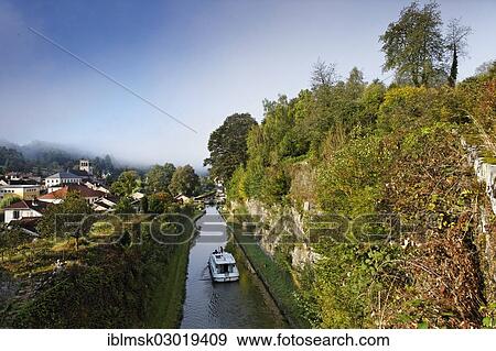 "Houseboat on the Canal des Vosges, formerly Canal de l'Est, with the rocks cut through above lock No. 35, Fontenoy-le-Chateau, Epinal, Lorraine, Departement Vosges, France, Europe" View Large Photo Image Stock Photo - "Houseboat on the Canal des Vosges, formerly Canal de l'Est, with the rocks cut through above lock No. 35, Fontenoy-le-Chateau, Epinal, Lorraine, Departement Vosges, France, Europe". Fotosearch