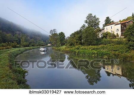 Stock Photo - "Houseboat on the Canal des Vosges, formerly Canal de l'Est, southwest of the village at about 127 PK, in the morning, Fontenoy-le-Chateau, Epinal, Lorraine, Departement Vosges, France, Europe". Fotosearch