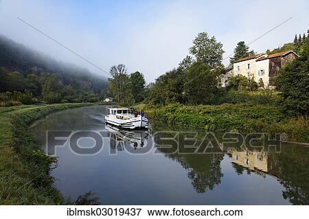 "Houseboat on the Canal des Vosges, formerly Canal de l'Est, southwest of the village at about 127 PK, in the morning, Fontenoy-le-Chateau, Epinal, Lorraine, Departement Vosges, France, Europe" View Large Photo Image Stock Photo - "Houseboat on the Canal des Vosges, formerly Canal de l'Est, southwest of the village at about 127 PK, in the morning, Fontenoy-le-Chateau, Epinal, Lorraine, Departement Vosges, France, Europe". Fotosearch