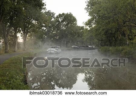 "Houseboat on the Canal des Vosges, formerly the Canal de l'Est, at PK 88, summit level of the canal, morning mood with morning fog, Les Forges, Epinal, Lorraine, Departement Vosges, France, Europe" View Large Photo Image Stock Photograph - "Houseboat on the Canal des Vosges, formerly the Canal de l'Est, at PK 88, summit level of the canal, morning mood with morning fog, Les Forges, Epinal, Lorraine, Departement Vosges, France, Europe". Fotosearch