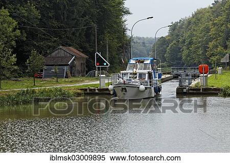 "Houseboat on the Canal des Vosges, formerly Canal de l'Est, staircase locks No's. 8 to 11 at PK 103, exit from the automatic lock, going upstream, Void-de Girancourt, Epinal, Lorraine, Departement Vosges, France, Europe" View Large Photo Image Stock Photography - "Houseboat on the Canal des Vosges, formerly Canal de l'Est, staircase locks No's. 8 to 11 at PK 103, exit from the automatic lock, going upstream, Void-de Girancourt, Epinal, Lorraine, Departement Vosges, France, Europe". Fotosearch