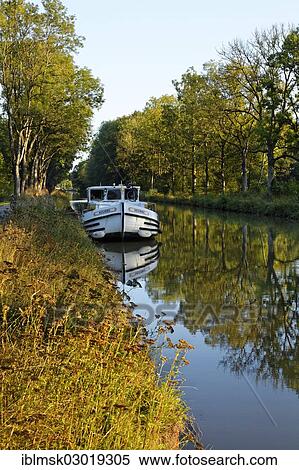 "Houseboat on the Canal des Vosges, formerly Canal de l'Est, at PK 100. 5, evening mood, Girancourt, Epinal, Lorraine, Departement Vosges, France, Europe" View Large Photo Image Stock Photography - "Houseboat on the Canal des Vosges, formerly Canal de l'Est, at PK 100. 5, evening mood, Girancourt, Epinal, Lorraine, Departement Vosges, France, Europe". Fotosearch