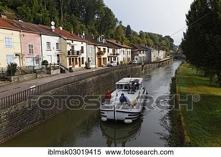 "Houseboat on the Canal des Vosges, formerly Canal de l'Est, passing through a village, Fontenoy-le-Chateau, Epinal, Lorraine, Departement Vosges, France, Europe" View Large Photo Image Stock Photography - "Houseboat on the Canal des Vosges, formerly Canal de l'Est, passing through a village, Fontenoy-le-Chateau, Epinal, Lorraine, Departement Vosges, France, Europe". Fotosearch