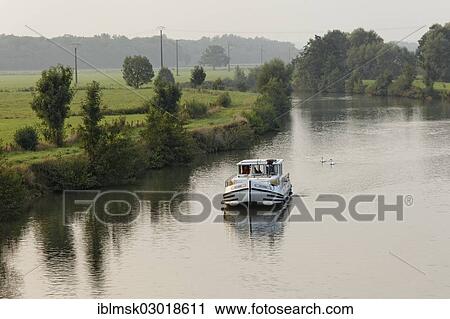 Stock Image - "Houseboat, penichette, on the Saone River, early morning at Baulay, PK 380, Fouchecourt, Vesoul, Region Franche-Comte, Dep. Haute-Saone, France, Europe". Fotosearch