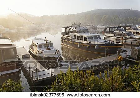 "Houseboats on the Saar river, Merzig Marina in the morning mist, Saarland, Germany, Europe" View Large Photo Image Stock Photography - "Houseboats on the Saar river, Merzig Marina in the morning mist, Saarland, Germany, Europe". Fotosearch
