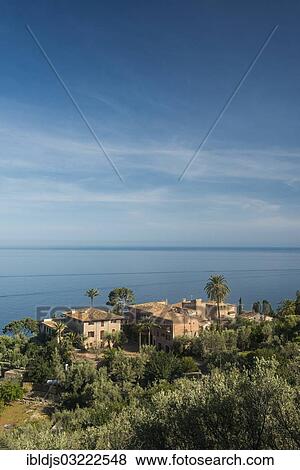 "Houses and palm tree by the sea, Lluc Alcari, Deia, Majorca, Balearic Islands, Spain, Europe" View Large Photo Image Stock Photo - "Houses and palm tree by the sea, Lluc Alcari, Deia, Majorca, Balearic Islands, Spain, Europe". Fotosearch