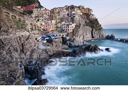 Picture - "Houses of Manarola on the rocky coast at dusk, UNESCO World Cultural Heritage Site, Manarola, Cinque Terre, Liguria, Italy, Europe". Fotosearch