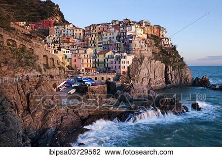 Stock Image - "Houses of Manarola on the rocky coast at dusk, UNESCO World Cultural Heritage Site, Manarola, Cinque Terre, Liguria, Italy, Europe". Fotosearch