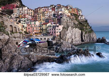 Stock Photo - "Houses of Manarola on the rocky coast at dusk, UNESCO World Cultural Heritage Site, Manarola, Cinque Terre, Liguria, Italy, Europe". Fotosearch