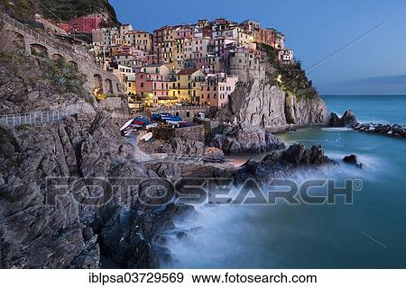 Stock Photo - "Houses of Manarola on the rocky coast at dusk, UNESCO World Cultural Heritage Site, Manarola, Cinque Terre, Liguria, Italy, Europe". Fotosearch