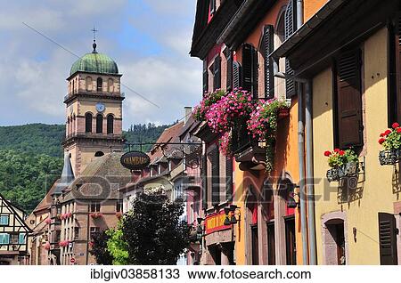 Stock Image - "Houses on Rue du General de Gaulle in front of the Church of Sainte-Croix, Kaysersberg, Alsace, Haut-Rhin, France, Europe". Fotosearch