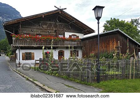"Houses with Geraniums (Pelargonium) and a cottage garden, Garmisch-Partenkirchen, Bavaria, Germany, Europe" View Large Photo Image Stock Photo - "Houses with Geraniums (Pelargonium) and a cottage garden, Garmisch-Partenkirchen, Bavaria, Germany, Europe". Fotosearch
