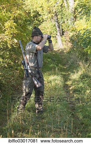 "Hunter observing game with binoculars, Offheim, Limburg an der Lahn, Hesse, Germany, Europe" View Large Photo Image Stock Image - "Hunter observing game with binoculars, Offheim, Limburg an der Lahn, Hesse, Germany, Europe". Fotosearch