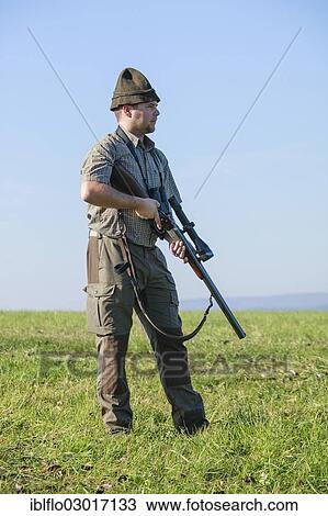 "Hunter standing on a meadow, waiting for game, Offheim, Limburg an der Lahn, Hesse, Germany, Europe" View Large Photo Image Stock Image - "Hunter standing on a meadow, waiting for game, Offheim, Limburg an der Lahn, Hesse, Germany, Europe". Fotosearch