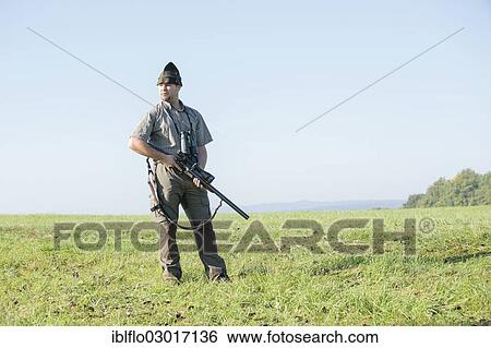 "Hunter standing on a meadow, waiting for game, Offheim, Limburg an der Lahn, Hesse, Germany, Europe" View Large Photo Image Stock Photograph - "Hunter standing on a meadow, waiting for game, Offheim, Limburg an der Lahn, Hesse, Germany, Europe". Fotosearch