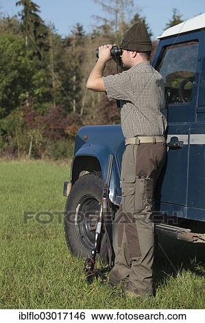 "Hunter watching game with binoculars, Offheim, Limburg an der Lahn, Hesse, Germany, Europe" View Large Photo Image Stock Photograph - "Hunter watching game with binoculars, Offheim, Limburg an der Lahn, Hesse, Germany, Europe". Fotosearch