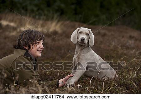 Huntress with Weimaraner puppy View Large Photo Image Picture - Huntress with Weimaraner puppy. Fotosearch
