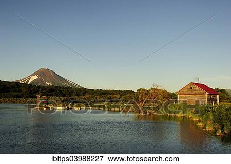 Stock Photo - "Hut of a fisheries supervisor at Kurile Lake, Ilinskaya volcano at the back, Kurilensee, Kamchatka Peninsula, Russia, Europe". Fotosearch