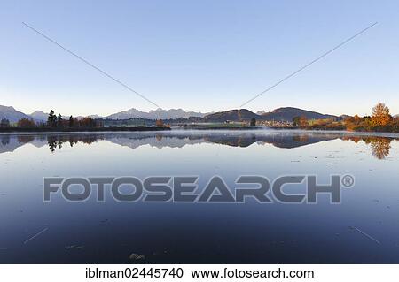 "Huttlerweiher pond, Rosshaupten, Tannheim Mountains at the rear, Ostallgaeu, Allgaeu, Swabia, Bavaria, Germany, Europe" View Large Photo Image Stock Image - "Huttlerweiher pond, Rosshaupten, Tannheim Mountains at the rear, Ostallgaeu, Allgaeu, Swabia, Bavaria, Germany, Europe". Fotosearch