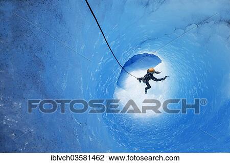 Stock Image - "Ice climbing in an ice cave or glacier cave, glacier crossing, Grey Glacier, Torres del Paine National Park, Chile, South America". Fotosearch